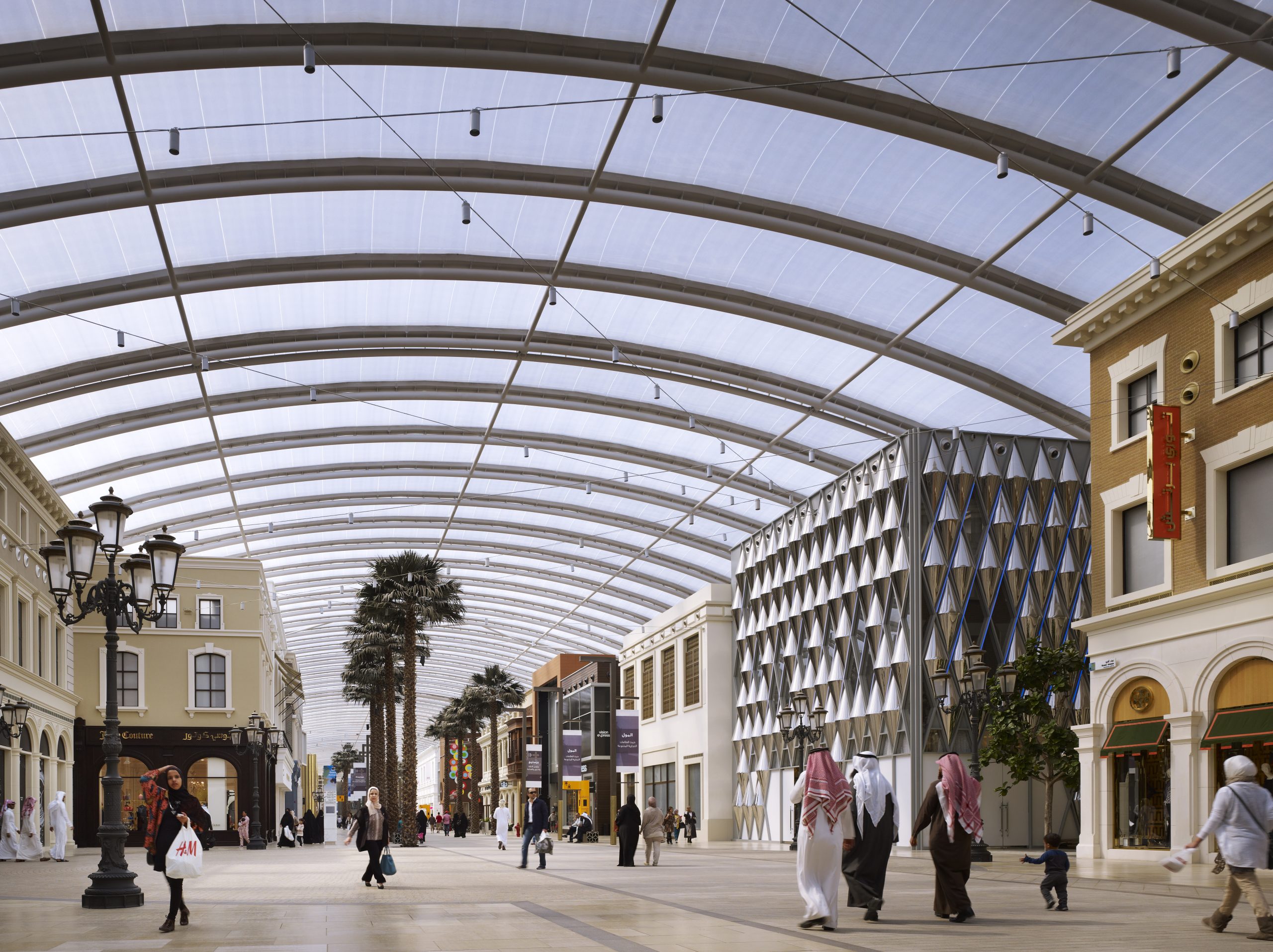 Outdoor view of The Avenues mall in Kuwait, featuring spacious walkways, modern retail spaces, and vibrant lighting.