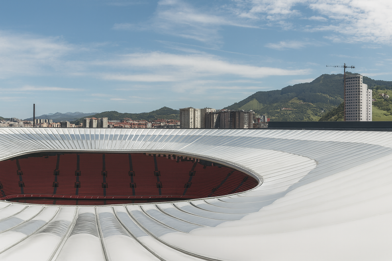 Bilbao San Mamés Stadium in Spain with a dynamic Lightspan ETFE system façade, glowing at night and showcasing modern architectural design.