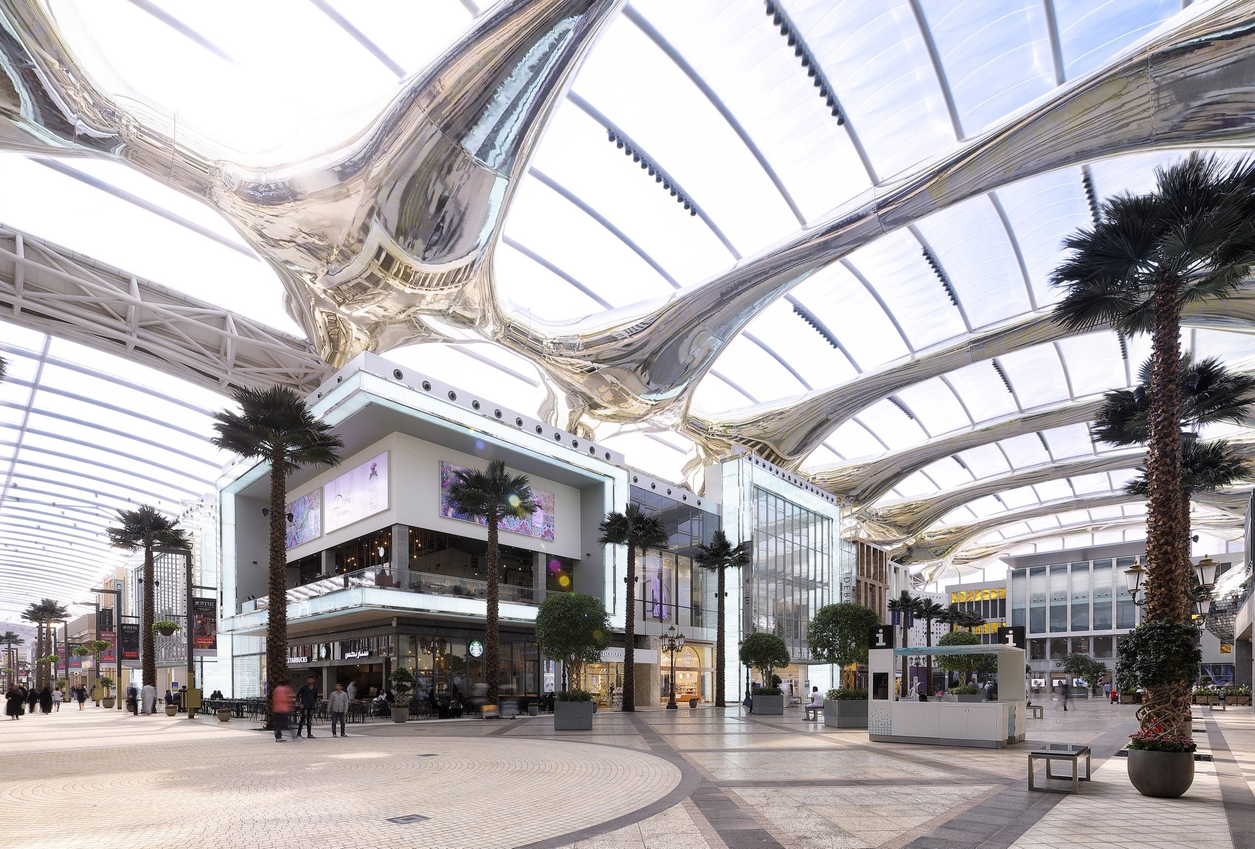 Interior of The Avenues mall in Kuwait, featuring spacious walkways, modern retail spaces, and vibrant lighting.