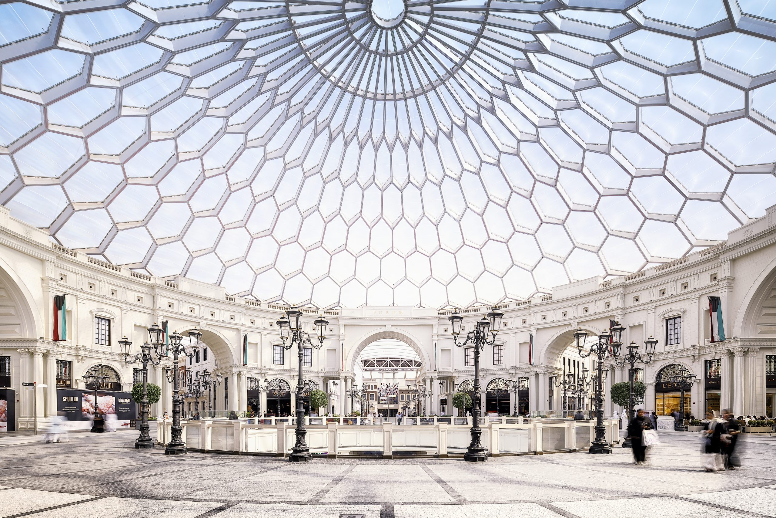 Outdoor view of The Avenues mall in Kuwait, featuring spacious walkways, modern retail spaces, and vibrant lighting.