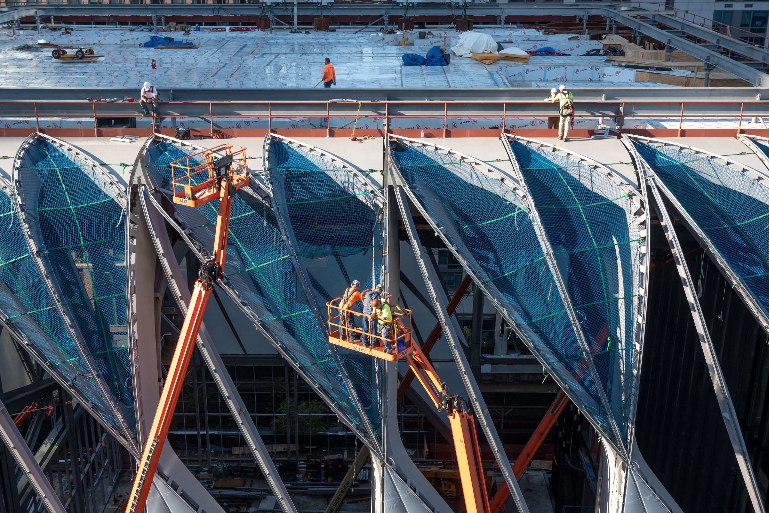 Construction of The Shed in New York City underway, showing the steel framework and retractable shell structure partially assembled.