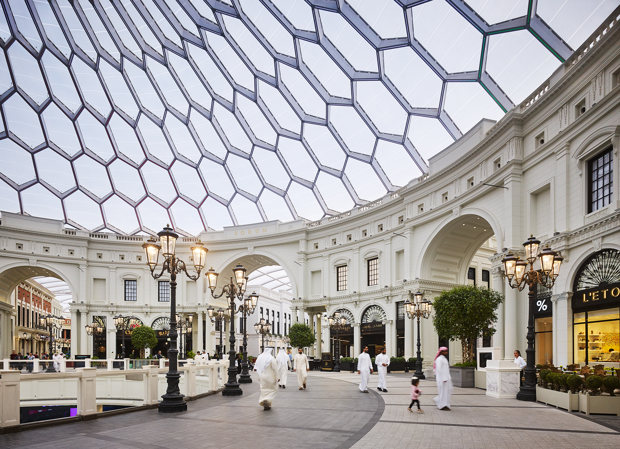 Outdoor view of The Avenues mall in Kuwait, featuring spacious walkways, modern retail spaces, and vibrant lighting.